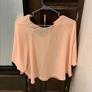 Peach shirt, with black bow in back